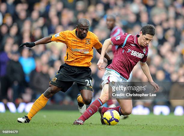 Guillermo Franco of West Ham turns away from George Boateng of Hull during the Barclays Premier League match between West Ham United and Hull City at...
