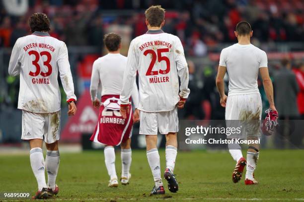 Mario Gomez of Bayern, Philipp Lahm, Thomas Mueller and Diego Contento walk off the pitch dejected after a 1-1 draw of the Bundesliga match between...
