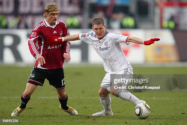 Marcel Risse of Nuernberg and Bastian Schweinsteiger of Bayern battle for the ball during the Bundesliga match between 1. FC Nuernberg and FC Bayern...