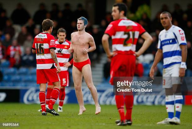 Streaker runs onto the pitch during the Coca-Cola Championship match between Queens Park Rangers and Doncaster Rovers at Loftus Road on February 20,...