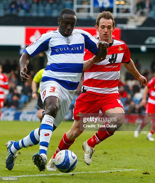 James Hayter of Doncaster Rovers and Damion Stewart of Queens Park Rangers battle for the ball during the Coca-Cola Championship match between Queens...