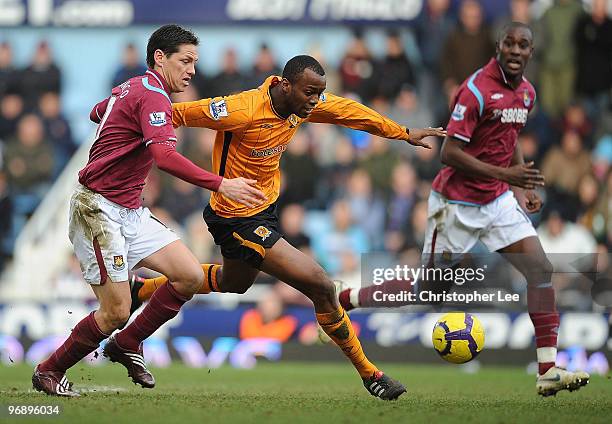 Steven Mouyokolo of Hull battles with Guillermo Franco of West Ham during the Barclays Premier League match between West Ham United and Hull City at...