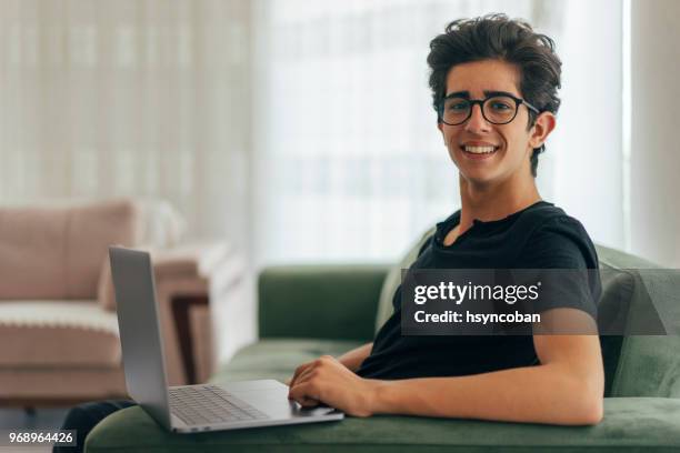 teenage boy using laptop at home - blonde boy stock pictures, royalty-free photos & images