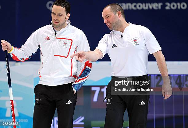 Skip David Murdoch of Great Britain and Northern Ireland confers with Euan Byers during the men's curling round robin game against China on day 9 of...