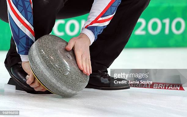 Third Ewan MacDonald of Great Britain and Northern Ireland wipes the stone during the men's curling round robin game against China on day 9 of the...