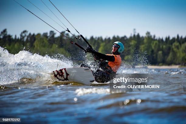 Former Finnish Olympic gymnastics athlete in Rome and Tokyo , Kauko Heikkinen rides a kitesurf in Storsand, northern Vaasa, western Finland, on May...