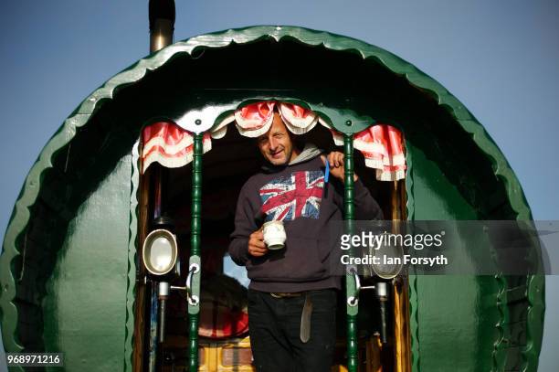 Jason Plant from Stoke on Trent stands in the door of his traditional bow top caravan after travelling for two weeks for the first day of the Appleby...