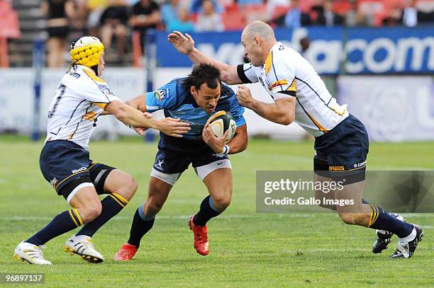 Matt Giteau and Stirling Mortlock of Brumbies tackle Francois Hougaard of Bulls during the Super 14 match between Vodacom Bulls and Brumbies from...