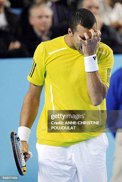 Jo-Wilfried Tsonga of France reacts after losing a point against his compatriot Julien Benneteau during the ATP Open 13 tennis semi final match on...