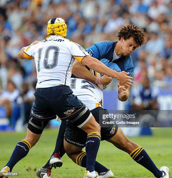 Matt Giteau and Christian Lealiifano of Brumbies tackle Zane Kirchner of Bulls during the Super 14 match between Vodacom Bulls and Brumbies from...