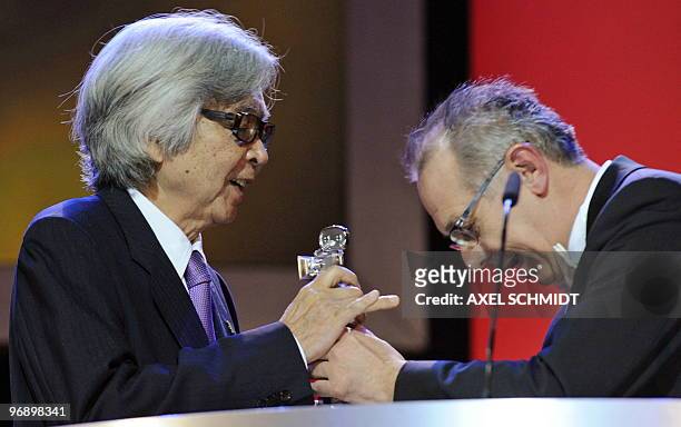 Japanese film director Yoji Yamada receives the Berlinale Kamera award for his life's work from Festival director Dieter Kosslick during the awards...