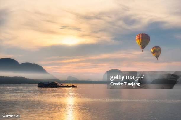 hot air balloons on the beach background is hill moutain fog and fisherman village - hot air balloon imagens e fotografias de stock