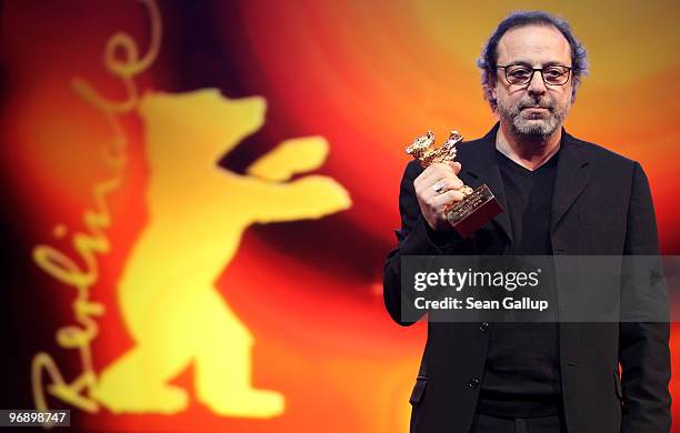 Director Semih Kaplanoglu holds up the Golden Bear Award for Best Film he received at the awards ceremony at the 60th Berlinale International Film...