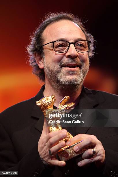 Director Semih Kaplanoglu holds up the Golden Bear Award for Best Film he received at the awards ceremony at the 60th Berlinale International Film...
