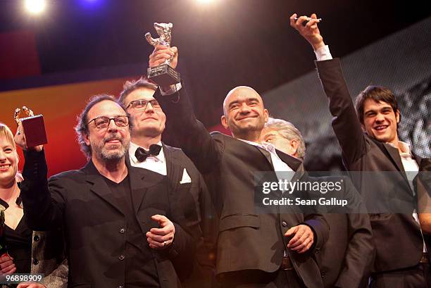 Director Semih Kaplanoglu holds up the Golden Bear Award for Best Film, director Florin Serban his Silber Bear and actor Sergei Puskepalis his Silver...