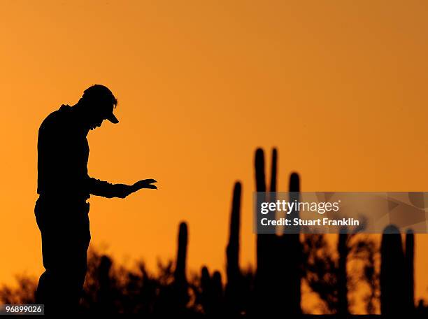 Thongchai Jaidee of Thailand checks his yardage on the first hole during round four of the Accenture Match Play Championship at the Ritz-Carlton Golf...