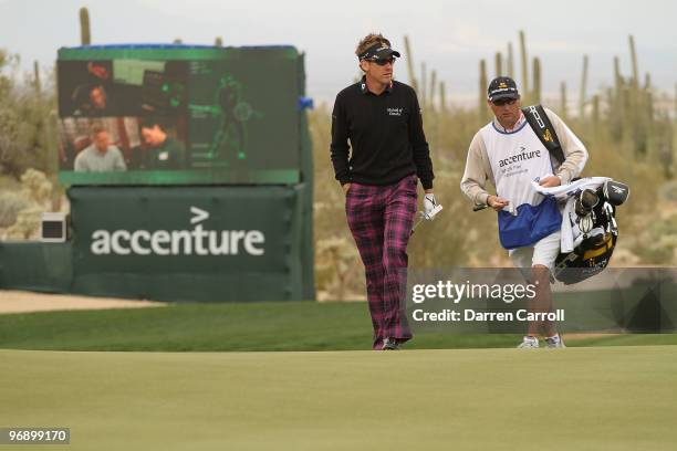 Ian Poulter of England and his caddy walk up the 13th hole during round four of the Accenture Match Play Championship at the Ritz-Carlton Golf Club...