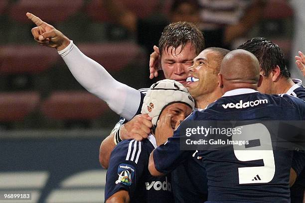 Bryan Habana of the Stormers is congratulated by his team mates as he points to the stands in celebration after scoring his second try during the...