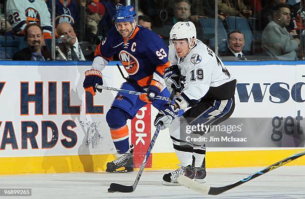 Stephane Veilleux of the Tampa Bay Lightning skates against Doug Weight of the New York Islanders on February 13, 2010 at Nassau Coliseum in...