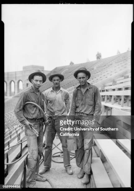 Photograph of 3 USC trackmen at work in coliseum, 3911 South Figueroa Street, Los Angeles, California, 1925.