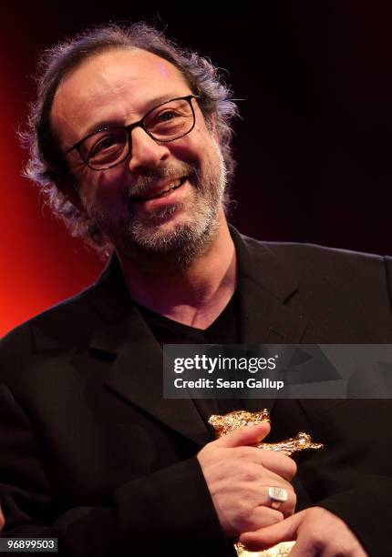 Director Semih Kaplanoglu holds up the Golden Bear Award for Best Film he received at the awards ceremony at the 60th Berlinale International Film...