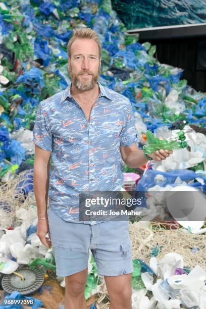 Ben Fogle stands in front giant wave of plastic waste collected from Holywell beach by the Marine Conservation Society, is seen on Old Street on June...