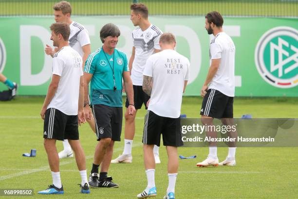 Joachim Loew, head coach of the German national team talks to his players during a training session of the German national team at Sportanlage Rungg...