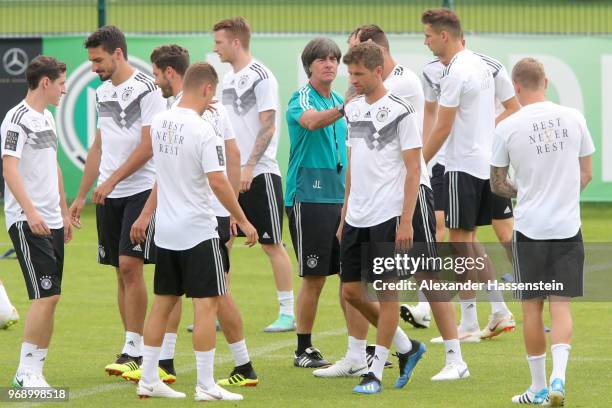 Joachim Loew, head coach of the German national team talks to his players during a training session of the German national team at Sportanlage Rungg...