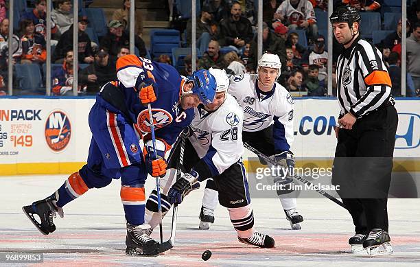 Doug Weight of the New York Islanders skates against Zenon Konopka of the Tampa Bay Lightning on February 13, 2010 at Nassau Coliseum in Uniondale,...