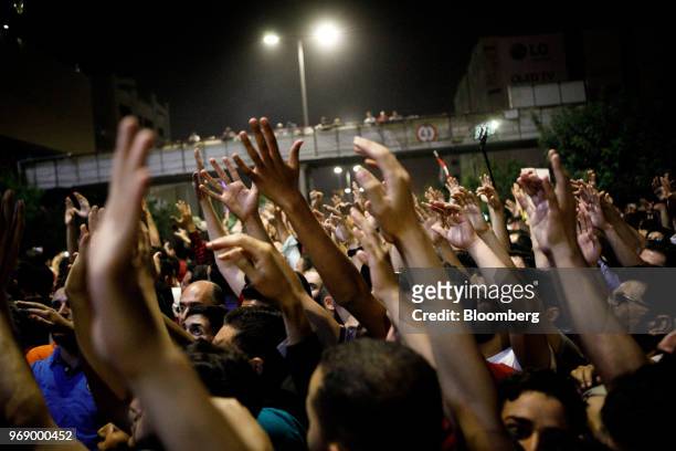 Protesters raise their arms during a demonstration against a draft income tax law near the prime minister's office in Amman, Jordan, on Wednesday,...