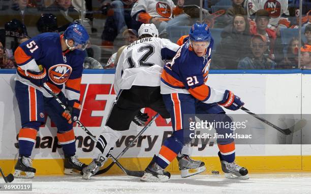 Kyle Okposo of the New York Islanders skates against Ryan Malone of the Tampa Bay Lightning on February 13, 2010 at Nassau Coliseum in Uniondale, New...