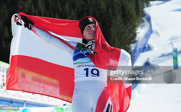 Andrea Fischbacher of Austria celebrates with the Austrian flag after winning the gold medal in the women's alpine skiing Super-G on day nine of the...