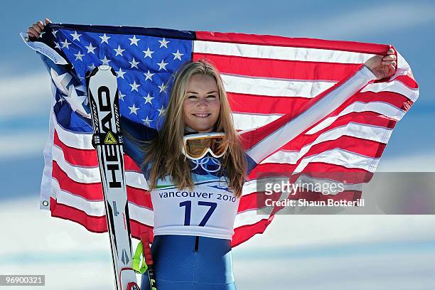 Bronze medalist Lindsey Vonn of the United States celebrates with the American flag after the women's alpine skiing Super-G on day nine of the...