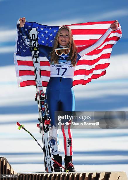 Bronze medalist Lindsey Vonn of the United States celebrates with the American flag after the women's alpine skiing Super-G on day nine of the...