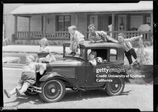 American child actress Mary Ann Jackson in a miniature car with Pete the Pup, and with fellow child actors from the 'Our Gang' comedy short film...