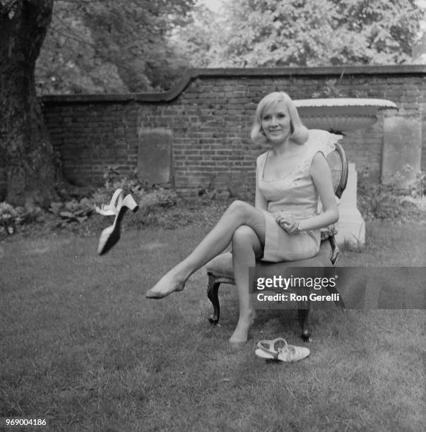 English singer Janie Jones takes out her shoes while sitting on a chair in a back garden after acquittal of vice and controlled prostitution charges,...