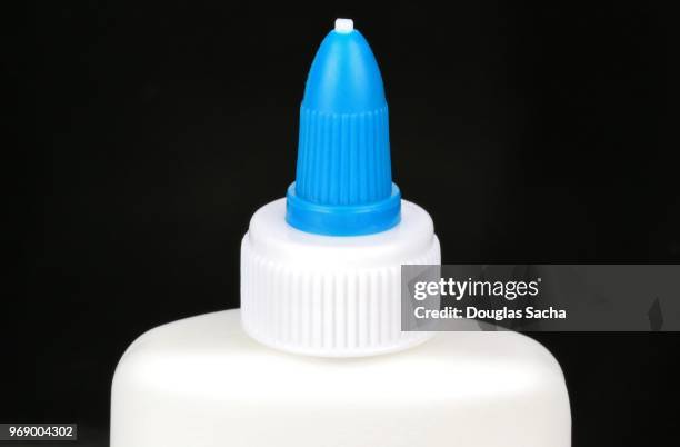 art and craft glue bottle on a black background - volume fluid capacity stock pictures, royalty-free photos & images