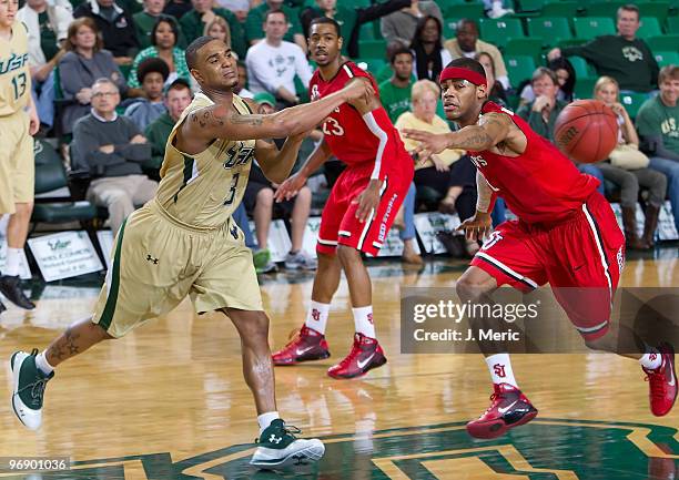 Chris Howard of the South Florida Bulls passes the ball as D.J. Kennedy of the St John's Red Storm defends during the game at the SunDome on February...
