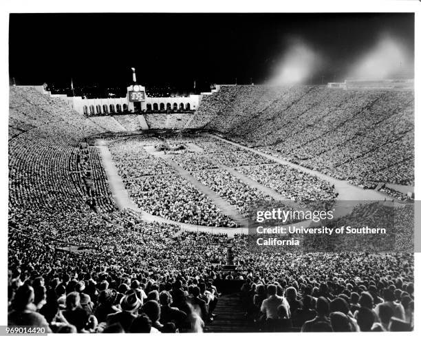 Religious service taking place at night in the Coliseum at Exposition Park, Los Angeles, California, early to mid twentieth century.