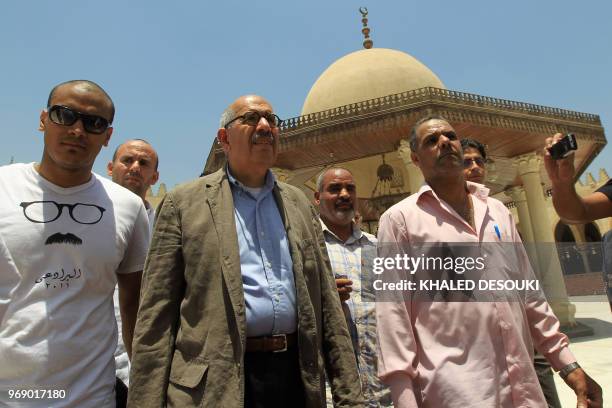 Egyptian Nobel Peace laureate and former UN atomic watchdog chief Mohamed ElBaradei walks past the Amr Ibn al-Aas mosque during a tour of the...