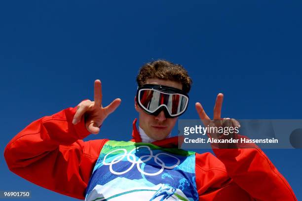 Simon Ammann of Switzerland poses for a photo after completing a jump on the Large Hill during day 9 of the 2010 Vancouver Winter Olympics at Ski...