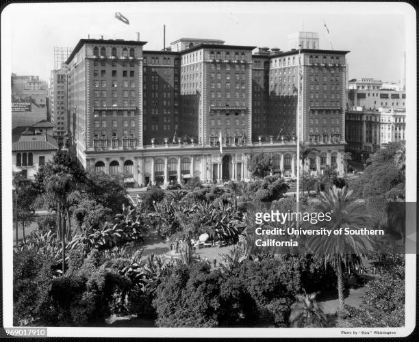 Looking west over the palms and banana trees of Pershing Square to the Biltmore Hotel, which opened in 1923, Los Angeles, California, early to mid...