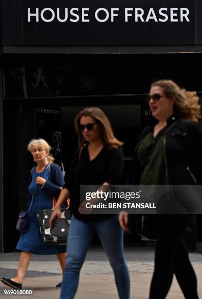 Pedestrians walk past the entrance to House of Fraser department store on Oxford Street in London on June 7, 2018. - Britain's department store chain...