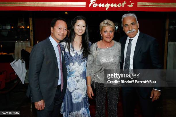 Michael Chang and his wife Amber Liu, Frederique Bahrami and Mansour Bahrami attend "Diner des Legendes" at Le Fouquet's on June 6, 2018 in Paris,...