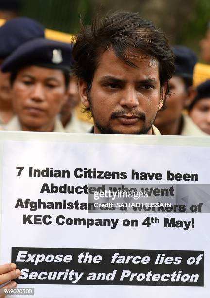 An Indian demonstrator holds a placard during a protest against the kidnaping of seven Indian citizens working in Afghanistan, in New Delhi on June...