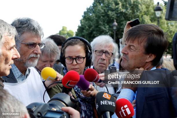 French Minister for the Ecological and Inclusive Transition Nicolas Hulot speaks with beekeepers at the Esplanade des Invalides in Paris on June 7...