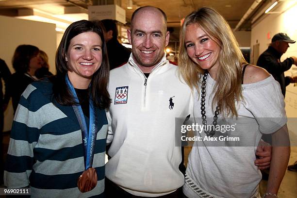 Snowboarders Kelly Clark and Gretchen Bleiler pose with coach Ricky Bower at USA House on February 19, 2010 during the Olympic Winter Games in...