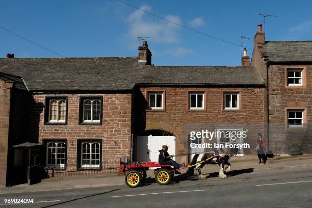 Horse and trap is driven through town on the first day of the Appleby Horse Fair on June 7, 2018 in Appleby, England.The fair is an annual gathering...