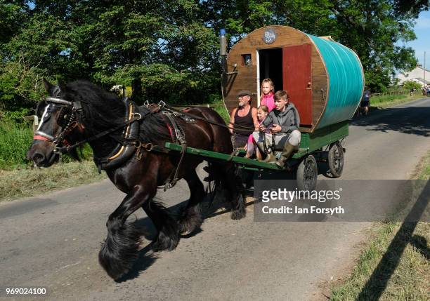 Traditional bow top caravan is driven to the campsite on the first day of the Appleby Horse Fair on June 7, 2018 in Appleby, England.The fair is an...