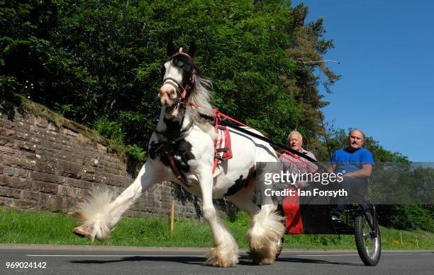 Horse and trap is driven along flashing lane on the first day of the Appleby Horse Fair on June 7, 2018 in Appleby, England.The fair is an annual...